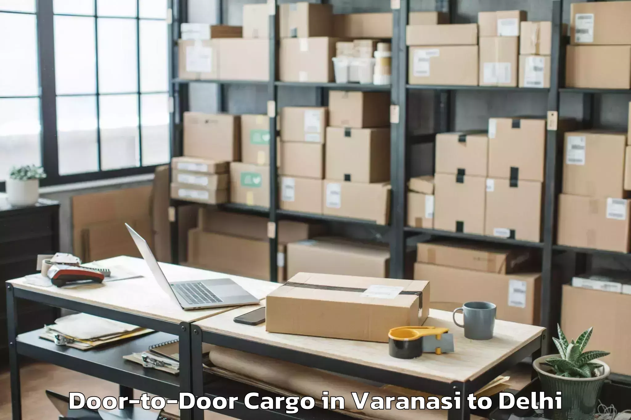 Book Varanasi to Dlf Promenade Mall Door To Door Cargo Online